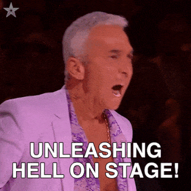 a man in a purple suit is saying unleashing hell on stage !