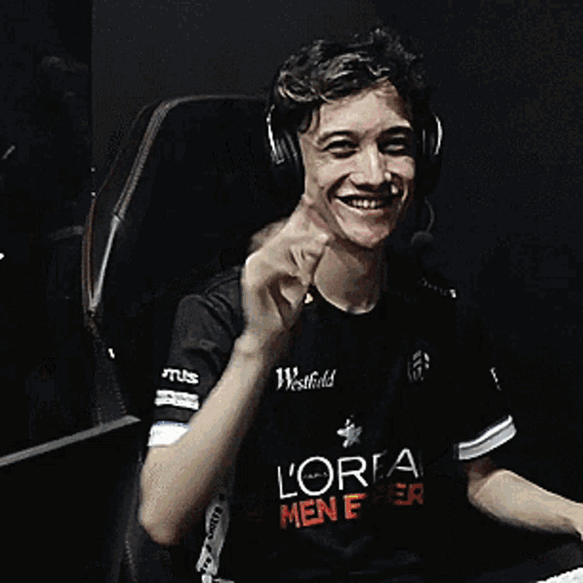 a man wearing headphones and a black shirt that says l' oreal on it