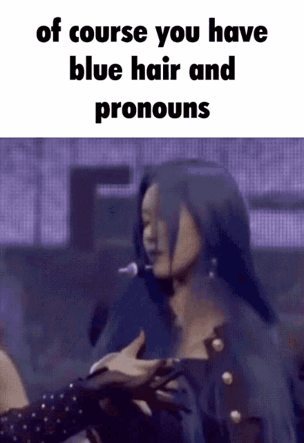 a woman with blue hair and pronouns is being held by another woman