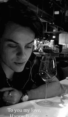 a man sitting at a table with a glass of wine and the words to you my love happy b day