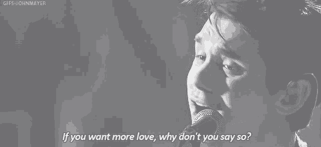 a black and white photo of a man singing into a microphone with a quote .