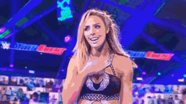 a woman is standing in front of a sign that says ' wwe ' on it