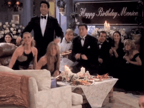 a group of people are dancing in front of a happy birthday monica sign