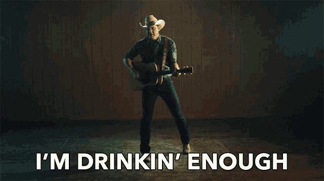 a man in a cowboy hat is playing a guitar with the words i 'm drinkin ' enough behind him