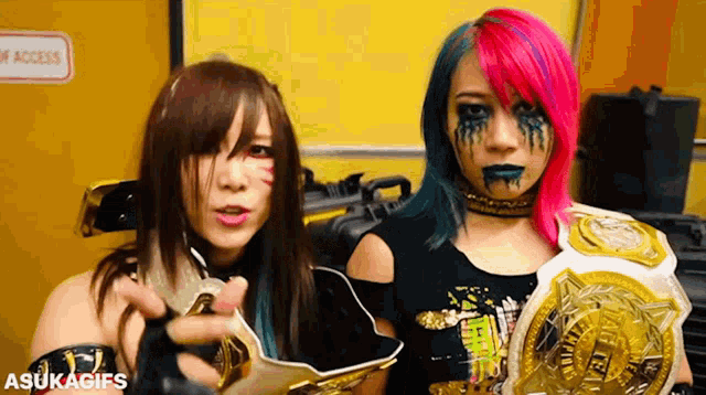 two female wrestlers standing next to each other with a sign that says no access