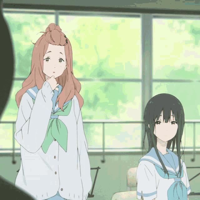 two anime girls are standing next to each other