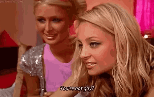 two women are sitting next to each other and one of them is saying `` you 're not gay ? ''