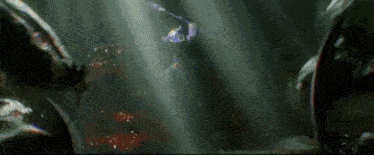a person is standing in a dark room with a light shining through the ceiling