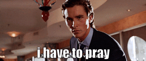 a man in a suit and tie is standing in front of a sign that says " i have to pray "