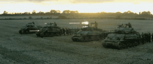 a group of military tanks are lined up in a field