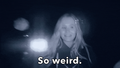 a woman in a dark room with the words so weird