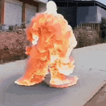 a person is covered in flames while walking down a street