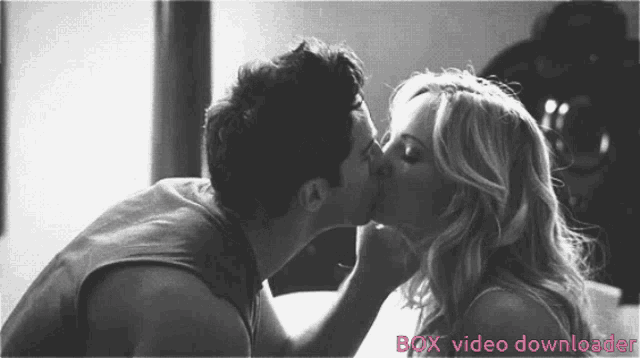 a black and white photo of a man and woman kissing with the words box video downloader below