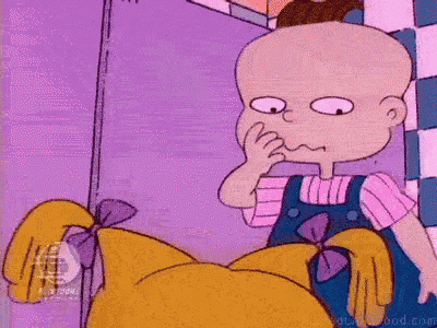 a cartoon character , rugrats , is standing next to another cartoon character in a bathroom .