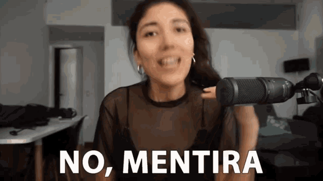 a woman stands in front of a microphone with the words no mentira behind her