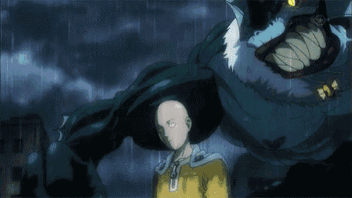 a bald man in a yellow shirt is standing in front of a monster with a large mouth .
