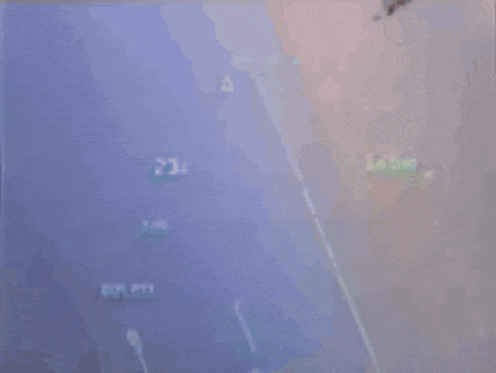 a plane is flying through a blue sky