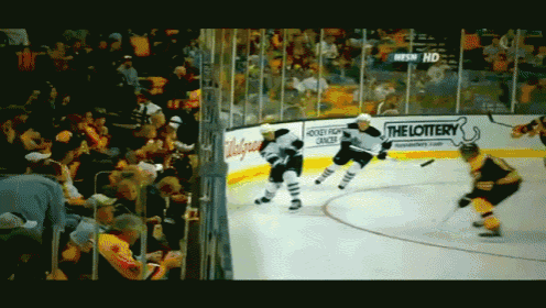 a hockey game is being played in front of a banner that says the lottery
