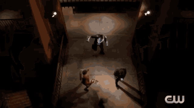 a person is laying on their back on the floor in a dark room .