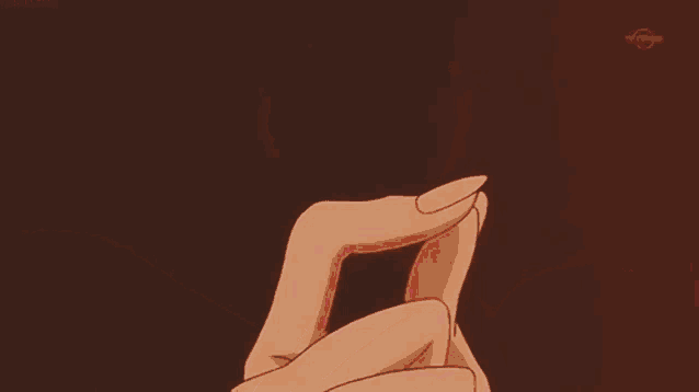 a close up of a person 's hand holding a red lightning bolt .