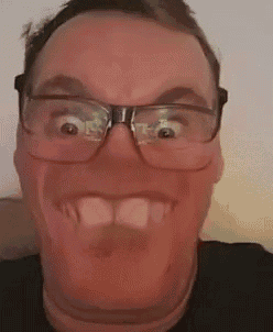 the man is wearing glasses and making a funny face .