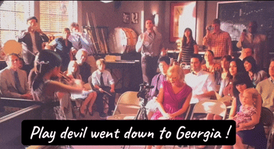 a group of people are gathered in a room with the words play devil went down to georgia on the bottom