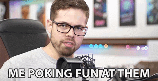 a man with glasses is sitting in front of a microphone with the words me poking fun at them below him
