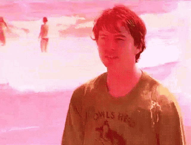 a man wearing a shirt that says ' owls head ' on it