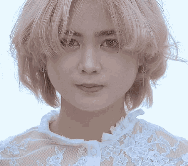 a woman with pink hair wearing a white lace top