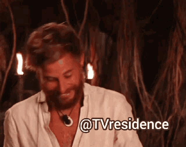 a man with a beard and a white shirt is smiling with the words @tvresidence above him