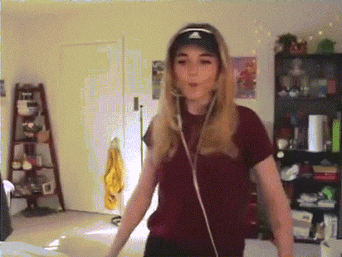 a girl wearing headphones and a hat with the adidas logo on it