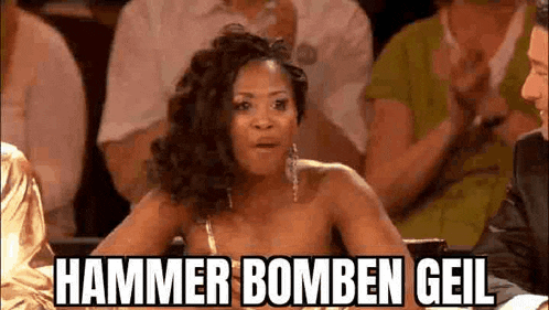 a woman is sitting in a crowd of people and saying `` hammer bomben gail `` .
