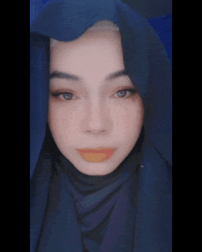 a close up of a woman wearing a blue scarf