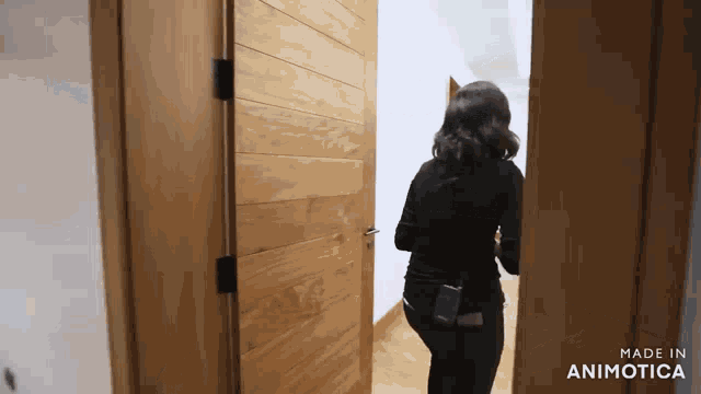 a woman standing in a doorway with the words made in animotica on the bottom