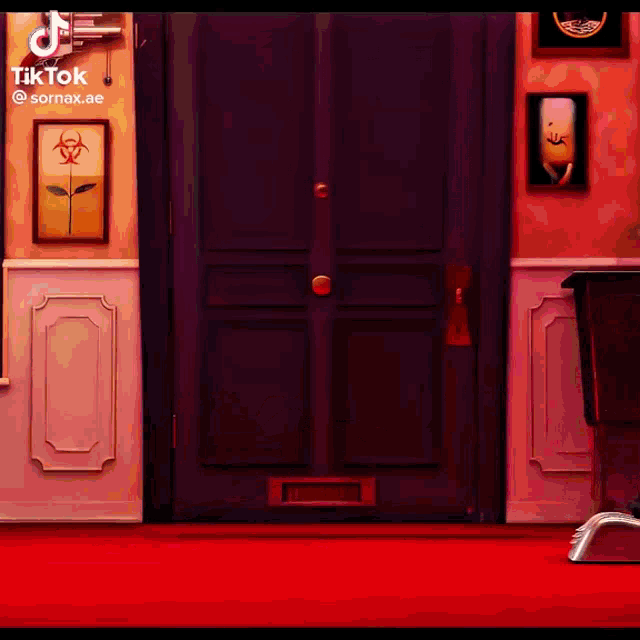 a room with a red carpet and a black door with a picture of a banana on the wall .