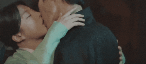 a man and woman are kissing and hugging each other
