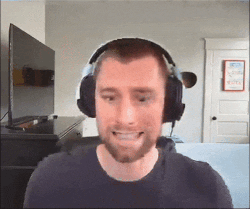 a man wearing headphones in front of a television