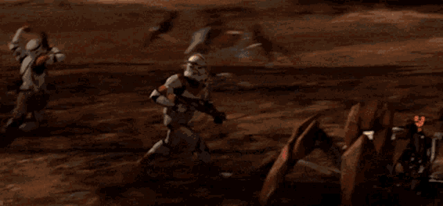 a group of stormtroopers are fighting each other in the desert