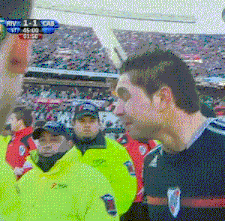 a soccer game is being played in a stadium and the score is 1-0