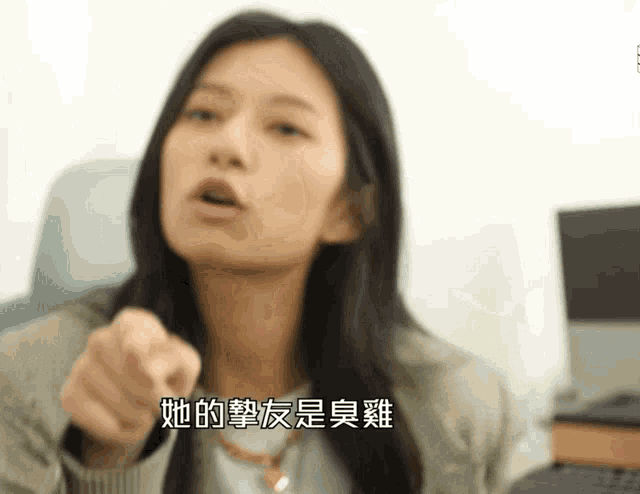 a woman with chinese writing on her face is pointing her finger