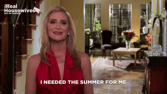 a woman in a red dress says " i needed the summer for me " in front of a living room
