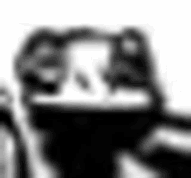 a black and white photo of a blurred image of a motorcycle .