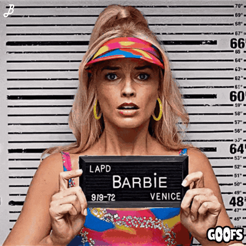 a woman is holding up a lapd barbie venice mugshot