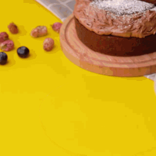 a slice of chocolate cake on a plate with blueberries and powdered sugar