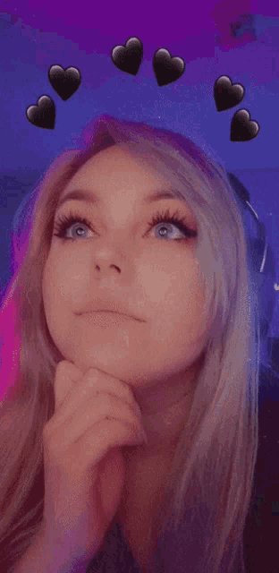 a close up of a woman 's face with hearts on it