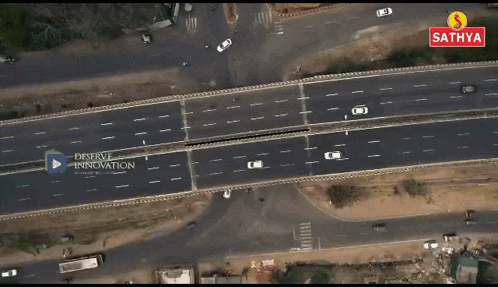 an aerial view of a train going down train tracks in a rural area .