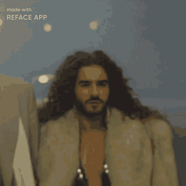 a man with long curly hair and a beard is wearing a fur coat