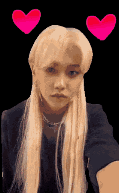 a woman with long blonde hair has two pink hearts above her head