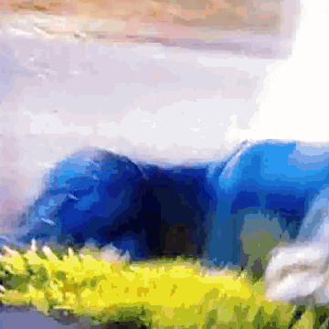 a pixelated image of a blue elephant laying in the grass