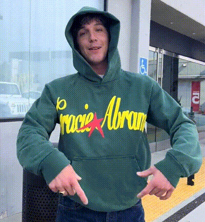 a man wearing a green hoodie with the word racie abram on it
